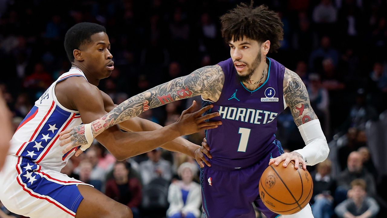 Charlotte Hornets guard LaMelo Ball (1) drives against Philadelphia 76ers guard V.J. Edgecombe during an NBA basketball game in Charlotte, N.C., Monday, Jan. 26, 2026. (AP File Photo/Nell Redmond)