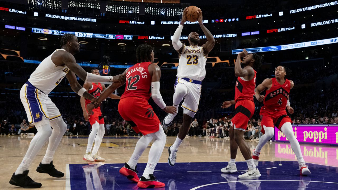 Los Angeles Lakers forward LeBron James (23) goes up for a basket during the first half of an NBA basketball game against the Toronto Raptors in Los Angeles.