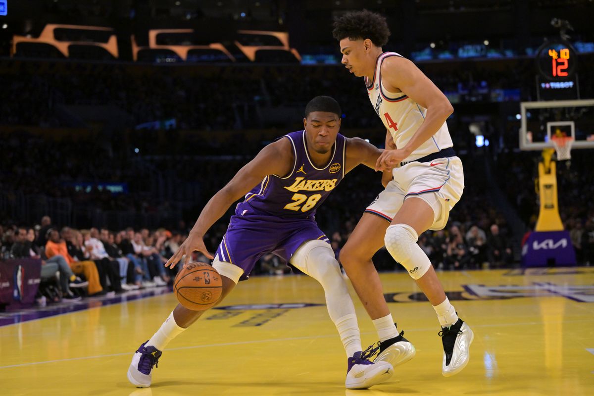Nov 25, 2025; Los Angeles, California, USA; Los Angeles Lakers forward Rui Hachimura (28) is defended by Los Angeles Clippers guard Kobe Sanders (4) during the first half at Crypto.com Arena. Mandatory Credit: Jayne Kamin-Oncea-Imagn Images