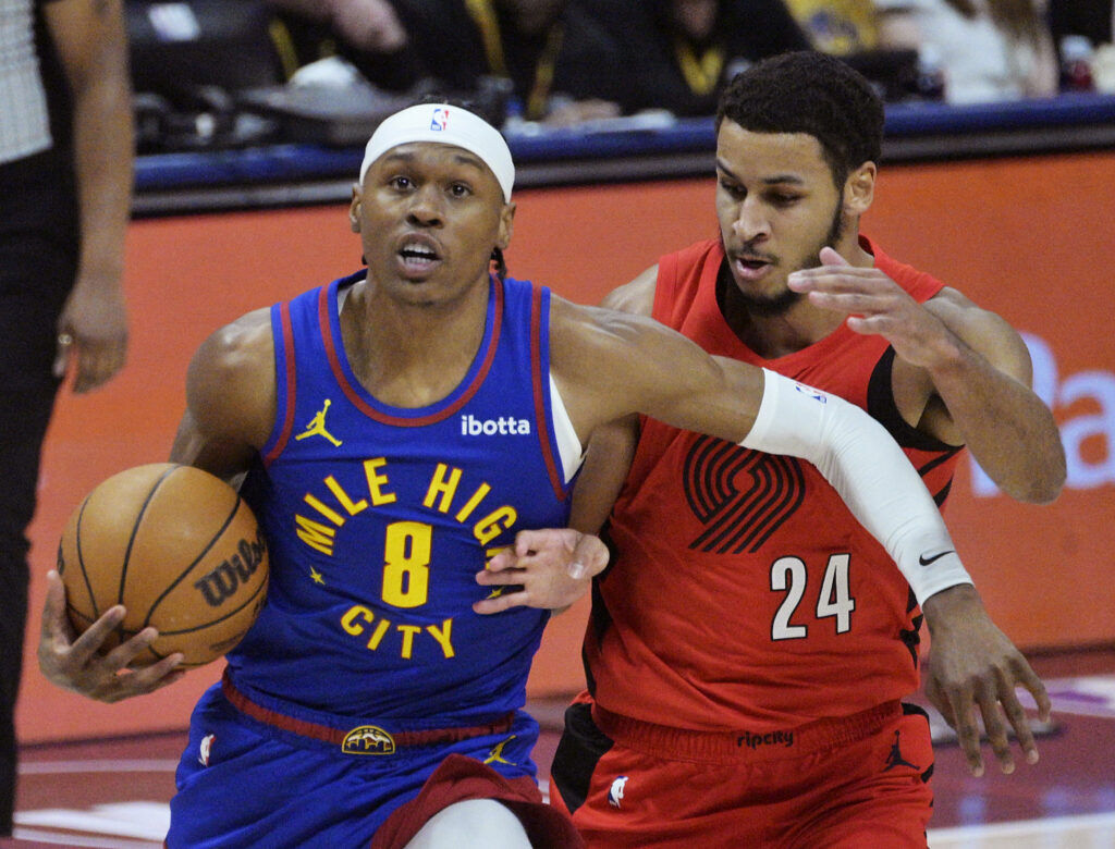 Nuggets Peyton Watson heads for the basket while being defended by Kris Murray in the first quarter of a game against the Trailblazers at Ball Arena on Sunday, March 22, 2026. (The Gazette, Jerilee Bennett)