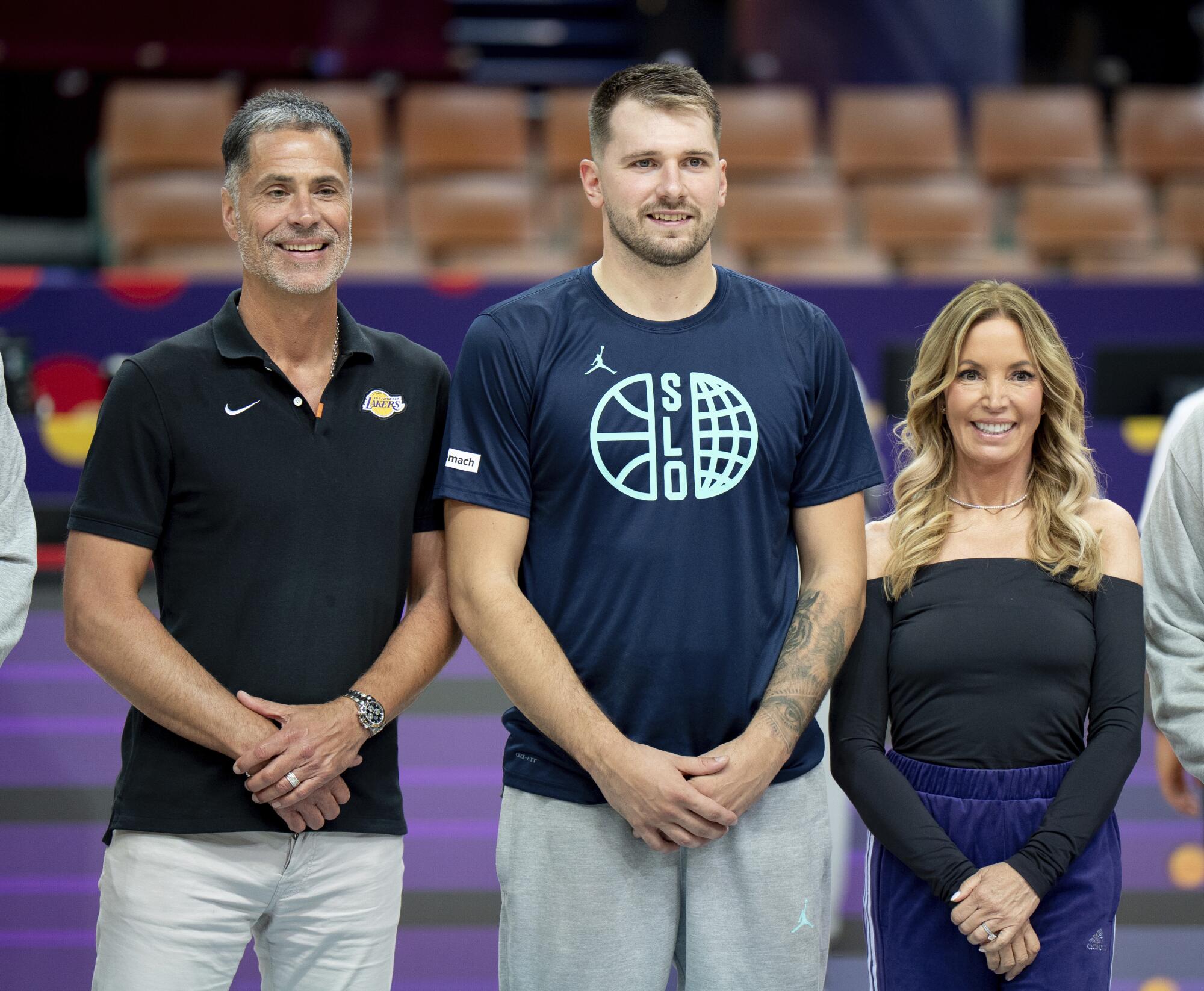 Rob Pelinka, Luka Doncic, and Jeanie Buss are seen in Katowice, Poland, on August 27, 2025.