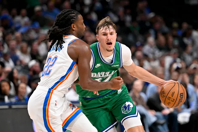 Oct 27, 2025; Dallas, Texas, USA; Dallas Mavericks forward Cooper Flagg (32) is fouled by Oklahoma City Thunder guard Cason Wallace (22) during the second half at the American Airlines Center. Mandatory Credit: Jerome Miron-Imagn Images