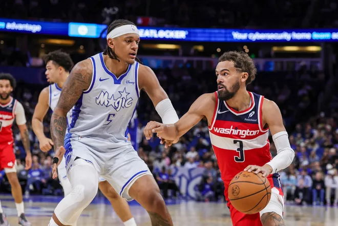 Mar 12, 2026; Orlando, Florida, USA; Washington Wizards guard Trae Young (3) drives against Orlando Magic forward Paolo Banchero (5) during the second quarter at Kia Center. Mandatory Credit: Mike Watters-Imagn Images