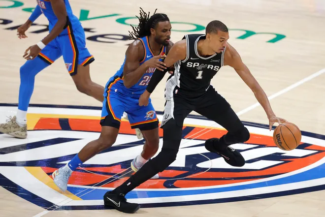 May 30, 2026; Oklahoma City, Oklahoma, USA; San Antonio Spurs forward Victor Wembanyama (1) controls the ball against Oklahoma City Thunder guard Cason Wallace (22) in the first quarter during game seven of the western conference finals for the 2026 NBA playoffs at Paycom Center. Mandatory Credit: Alonzo Adams-Imagn Images