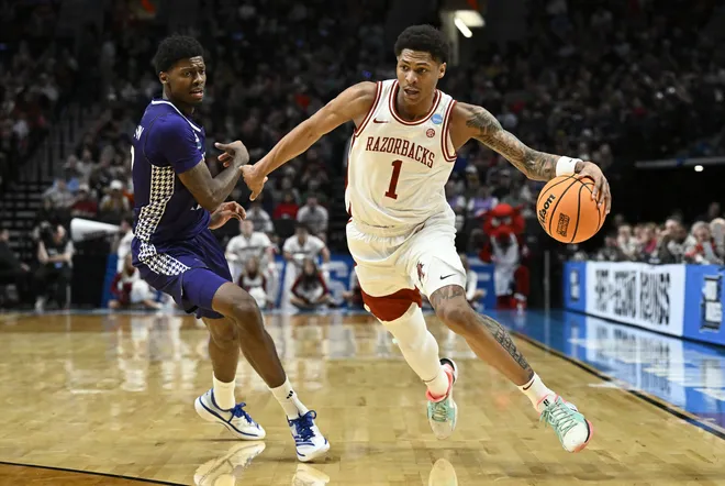 Mar 21, 2026; Portland, OR, USA; Arkansas Razorbacks guard Meleek Thomas (1) drives against High Point Panthers guard Scotty Washington (12) in the first half during a second round game of the men's 2026 NCAA Tournament at Moda Center. Mandatory Credit: Craig Strobeck-Imagn Images