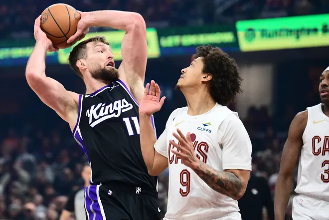 Jan 23, 2026; Cleveland, Ohio, USA; Sacramento Kings forward Domantas Sabonis (11) drives to the basket against Cleveland Cavaliers guard Craig Porter Jr. (9) during the first half at Rocket Arena. Mandatory Credit: Ken Blaze-Imagn Images