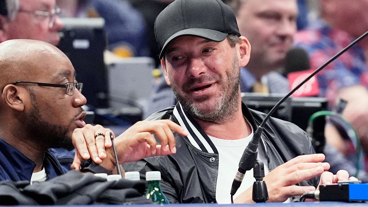 Former NFL quarterback Tony Romo, right, attends an NBA basketball game between the Indiana Pacers and the Dallas Mavericks on March 5, 2024, in Dallas.