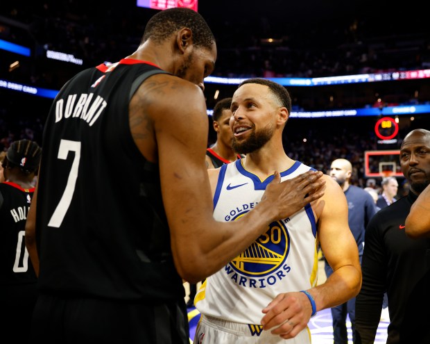 Golden State Warriors' Stephen Curry (30) chats with Houston Rockets' Kevin Durant (7) after the Warriors lost 117-116 at the Chase Center in San Francisco, Calif., on Sunday, April 5, 2026. (Nhat V. Meyer/Bay Area News Group)