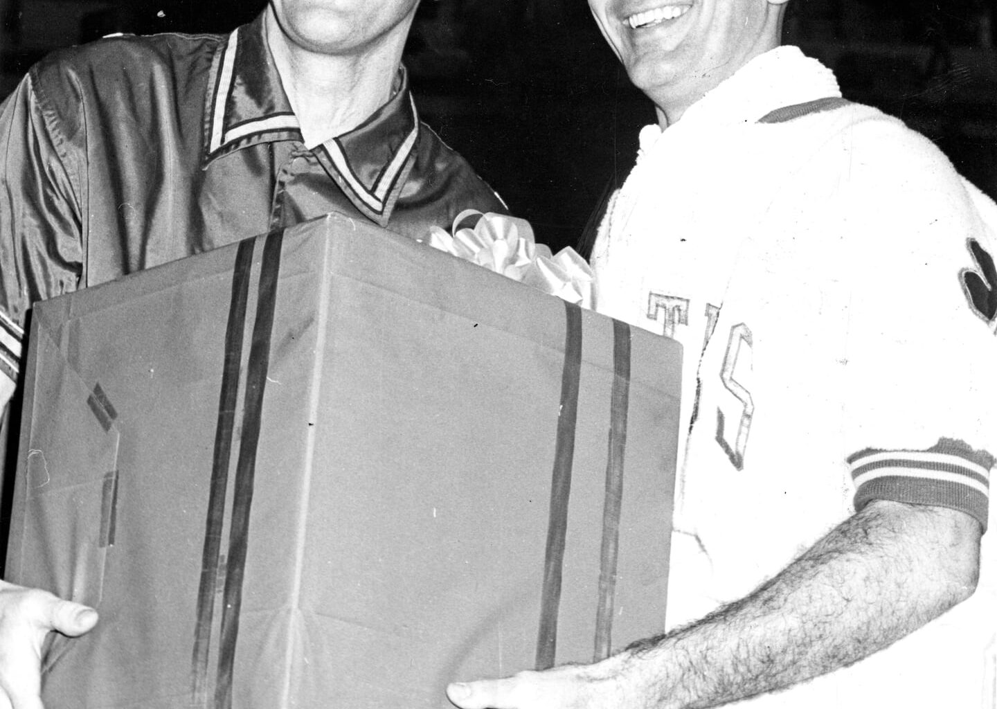 Syracuse Nationals player Dolph Schayes (left) presented retiring Celtics player Bob Cousy with a gift on "Bob Cousy Day" at the Boston Garden on March 17, 1963.