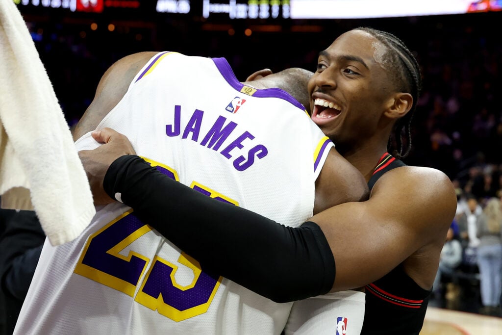 Tyrese Maxey #0 of the Philadelphia 76ers hugs Lebron James #23 of the Los Angeles Lakers after a game at Xfinity Mobile Arena on December 07, 2025 in Philadelphia, Pennsylvania. The Los Angeles Lakers won 112-108.