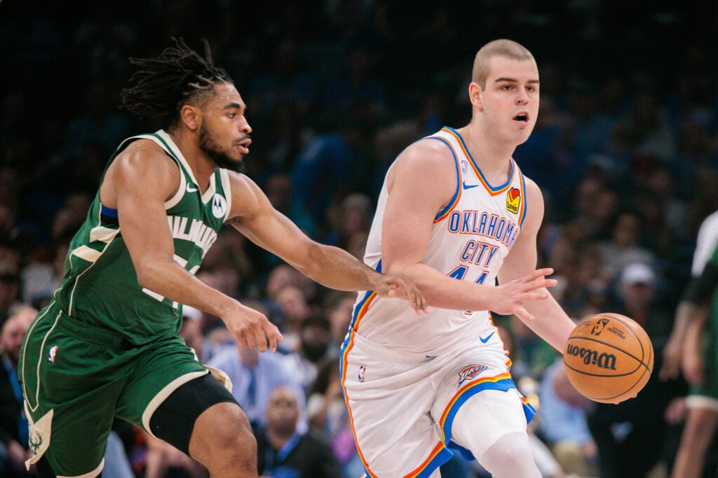 Nikola Topic #44 of the Oklahoma City Thunder drives to the basket past Cam Thomas #24 of the Milwaukee Bucks during the first half at Paycom Center on February 12, 2026 in Oklahoma City, Oklahoma.