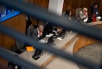 Portland Mayor Keith Wilson, center left, looks to his computer during the meeting.