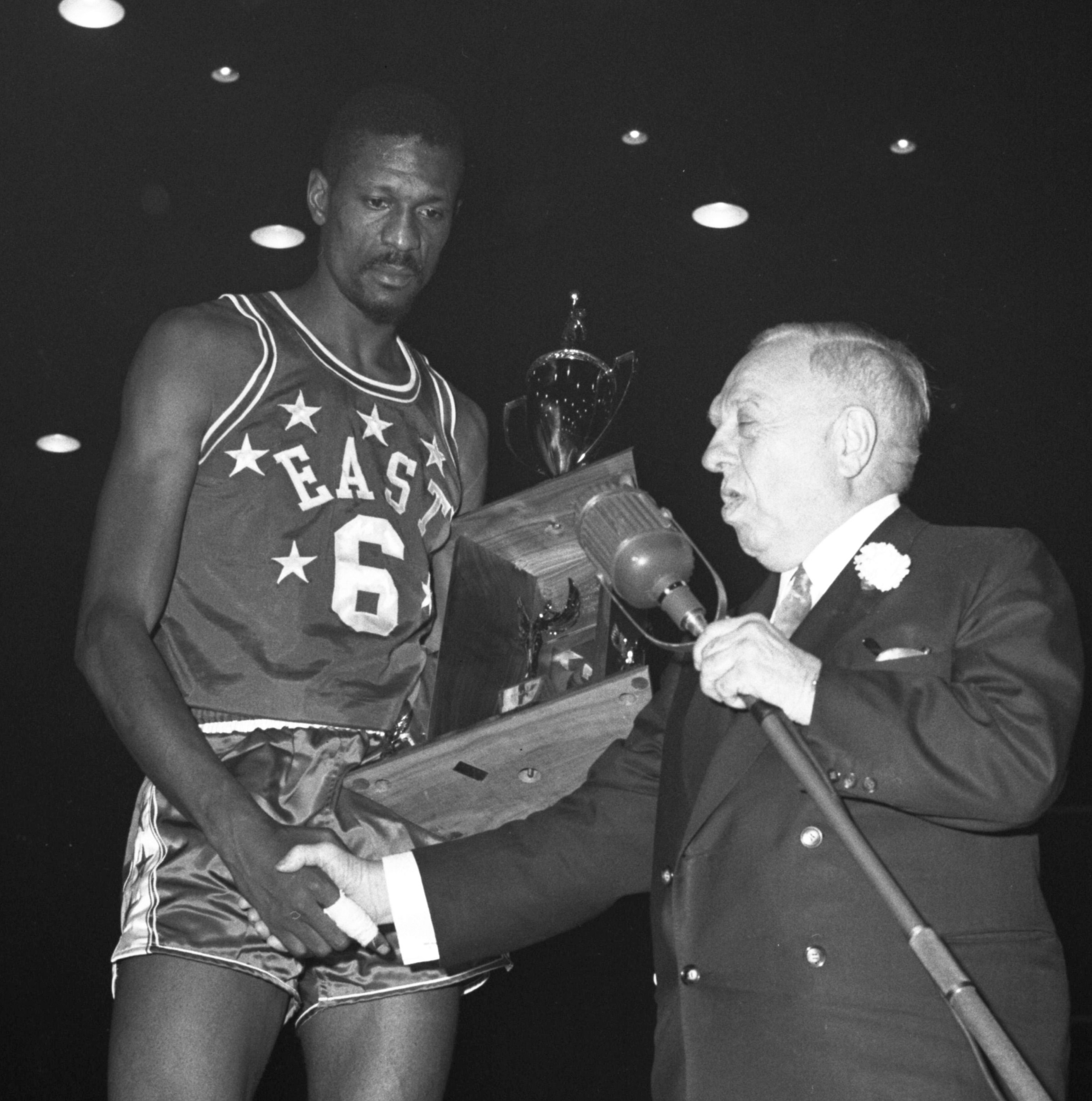Bill Russell received many MVP trophies in his career. Here’s one with congratulations from NBA president Maurice Podoloff. (Photo by Bettmann Archive/Getty Images)
