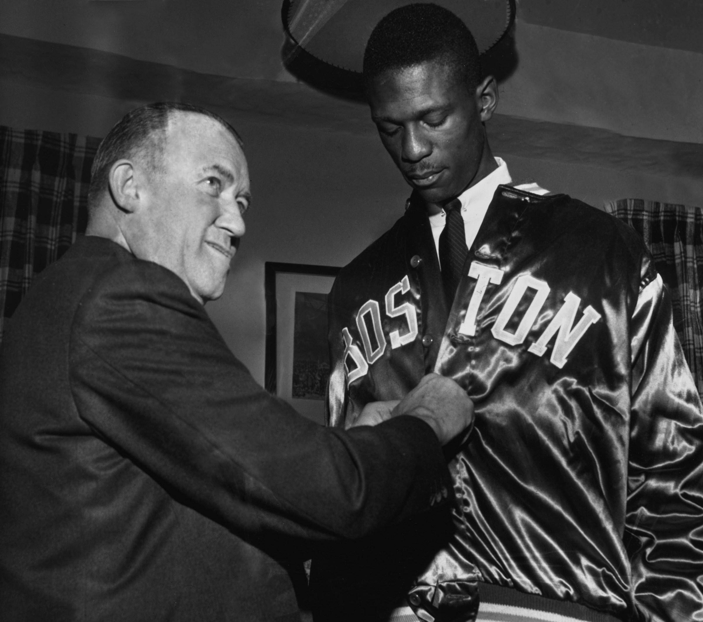 Celtics’ owner Walter Brown helps Bill Russell with his new team jacket, after the center signed his rookie contract in 1956. Brown, who founded the franchise, passed away September 7, 1964. (Photo by UPI/Bettmann Archive/Getty Images)