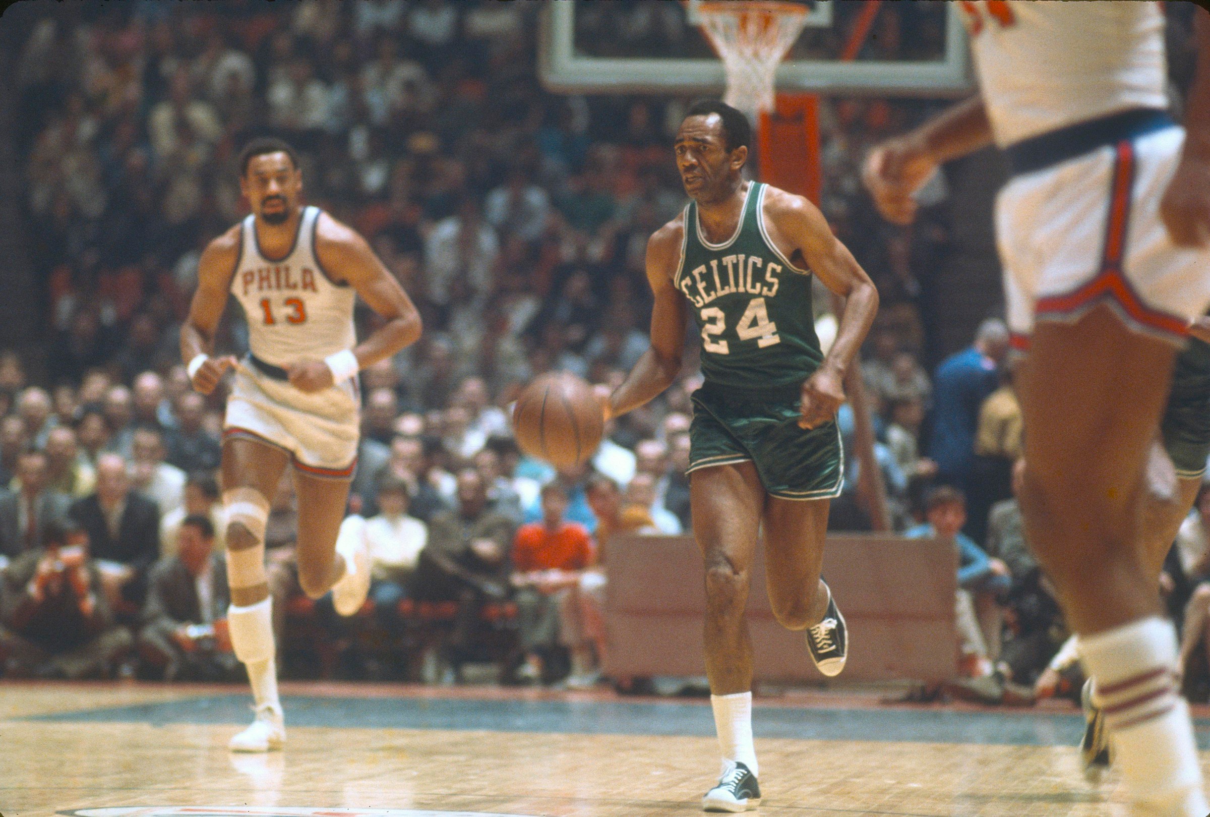 Sam Jones dribbles the ball upcourt against the Philadelphia 76ers circa 1965. In the background is Wilt Chamberlain, whom Jones was known to trash talk after Chamberlain failed to block his shot. “Too late,” Jones would say. (Photo by Focus on Sport/Getty Images)