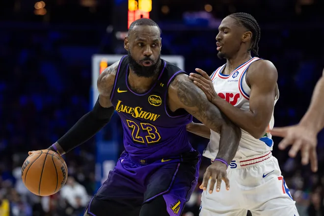 Jan 28, 2025; Philadelphia, Pennsylvania, USA; Los Angeles Lakers forward LeBron James (23) controls the ball against Philadelphia 76ers guard Tyrese Maxey (0) during the second quarter at Wells Fargo Center. Mandatory Credit: Bill Streicher-Imagn Images
