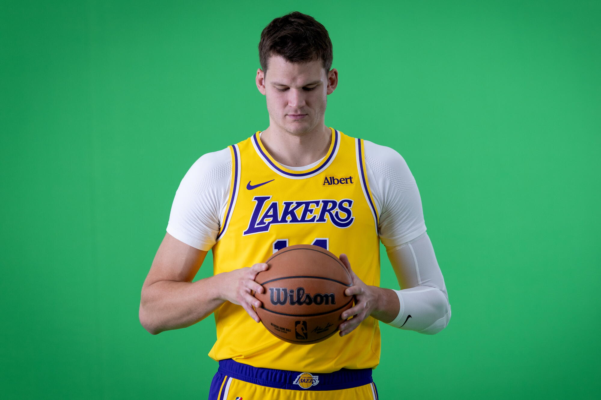 Lakers center Walker Kessler poses for photos and video during the team's media day in El Segundo.