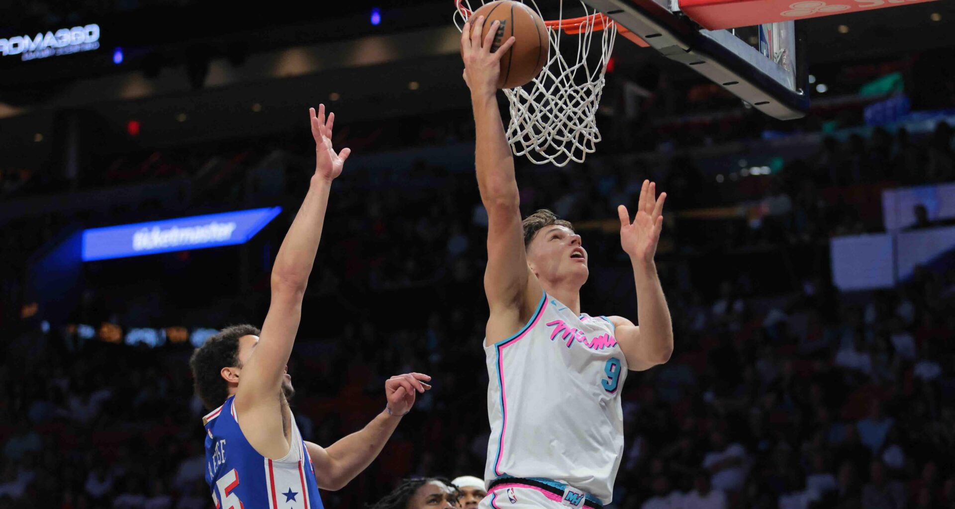 Miami Heat guard Pelle Larsson (9) scores past Philadelphia 76ers forward Alex Reese (65)