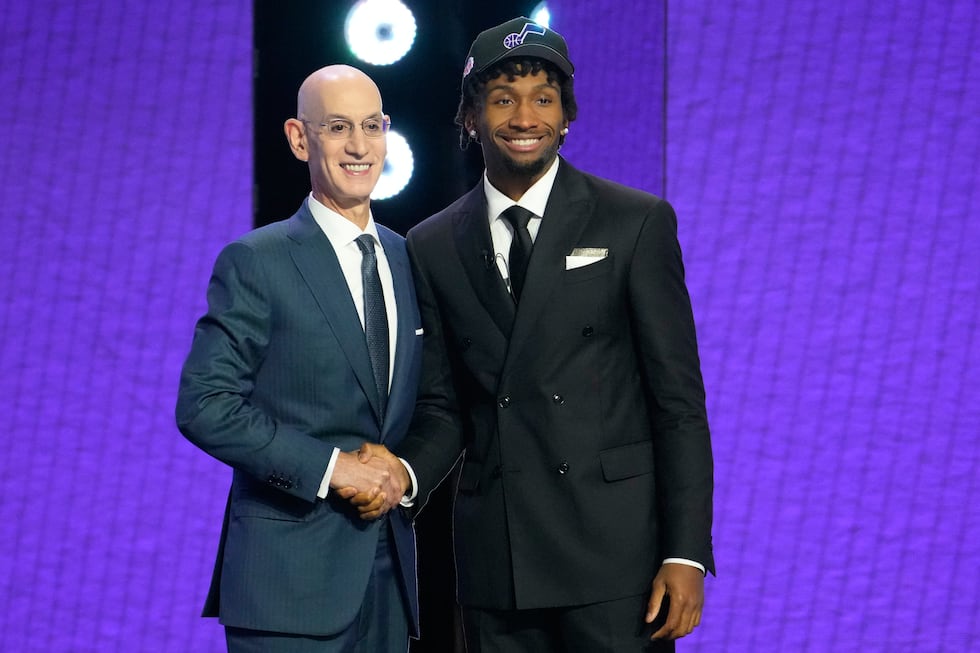 Darryn Peterson, right, poses for a photo with NBA Commissioner Adam Silver, left, after being...
