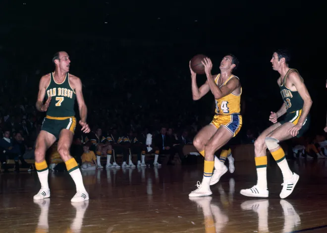 Unknown date; Los Angeles, CA, USA; FILE PHOTO; Los Angeles Lakers guard Jerry West (44) drives past San Diego Rockets forward Jim Barnett (33) and Toby Kimball (7) at the Forum. Mandatory Credit: Darryl Norenberg-USA TODAY Sports