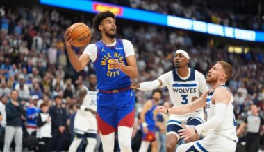 Denver Nuggets forward Cameron Johnson, left, passes the ball as Minnesota Timberwolves forward Jaden McDaniels, center, and guard Donte DiVincenzo defend in the first half