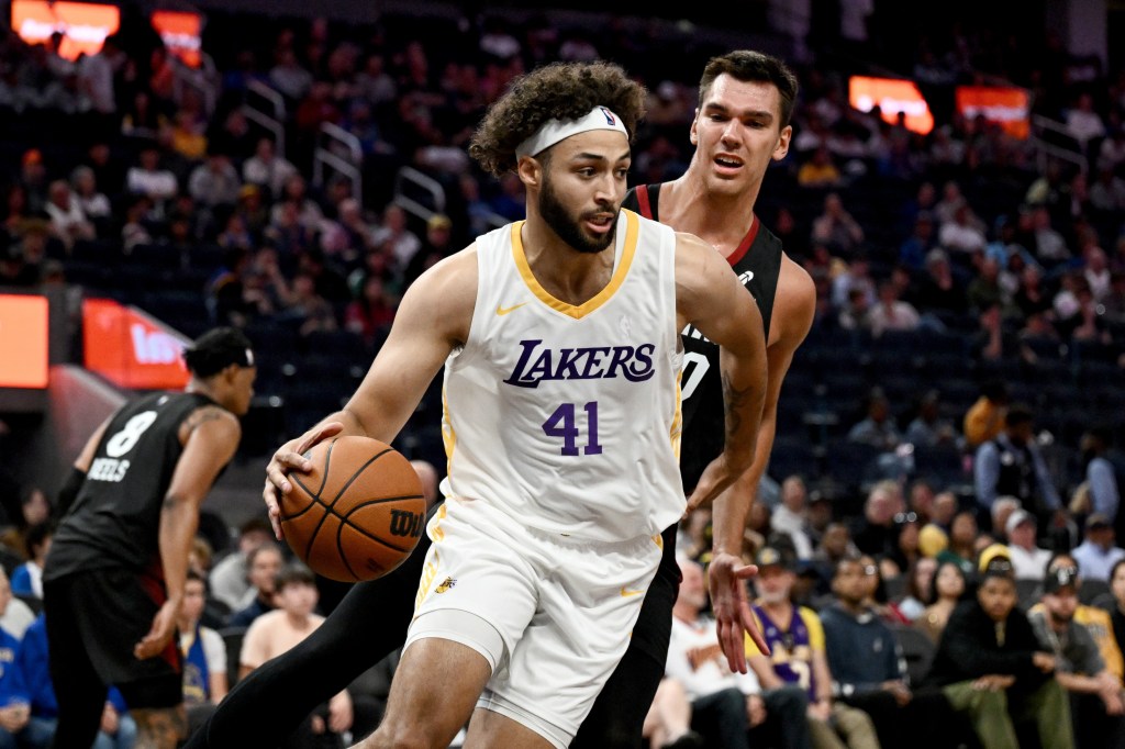 A Miami Heat player guards a Los Angeles Lakers player, number 41, who is dribbling a basketball.