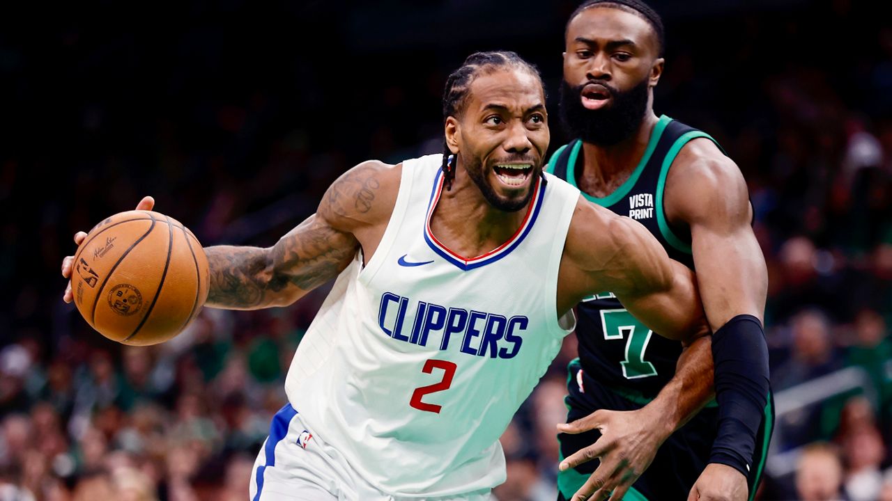 Los Angeles Clippers' Kawhi Leonard (2) drives past Boston Celtics' Jaylen Brown (7) during the first half of an NBA basketball game, Saturday, Jan. 27, 2024, in Boston. (AP Photo/Michael Dwyer)
