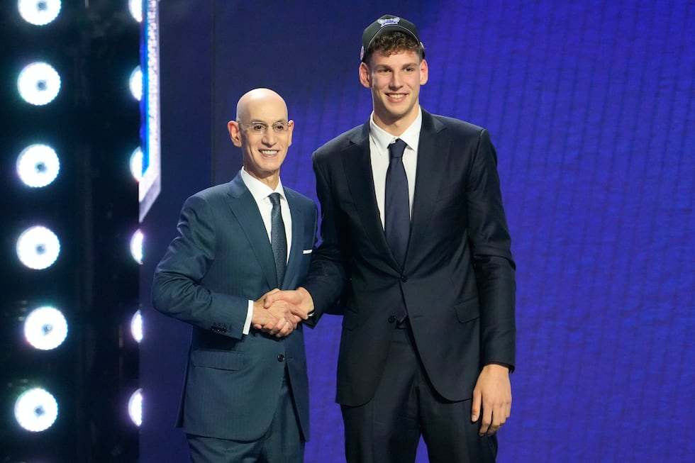 Hannes Steinbach, right, poses for a photo with NBA Commissioner Adam Silver, left, after...