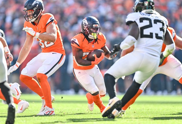 Jonah Coleman (20) of the Denver Broncos looks for space as Foyesade Oluokun (23) of the Jacksonville Jaguars defends during the fourth quarter of the Broncos' 20-13 win at Empower Field at Mile High in Denver, Colorado on Sunday, September 20, 2026. (Photo by AAron Ontiveroz/The Denver Post)