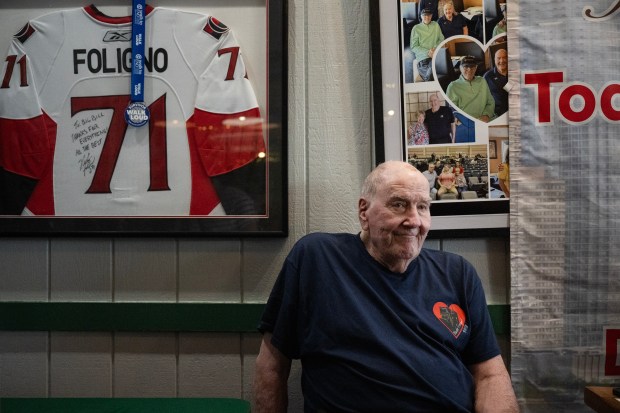 Owner Bill Ficke, a former Nuggets assistant coach and NBA scout, takes a seat between mingling with friends, family and patrons during the annual 