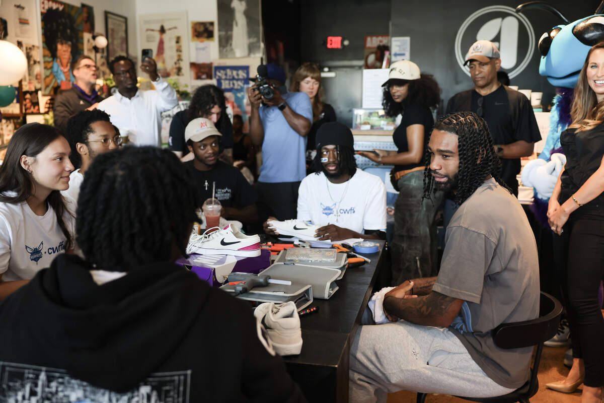 Coby White, right, guard for the Charlotte Hornets, talks to a group of youth Tuesday, July 7, 2026 at Archivve CLT in Charlotte.