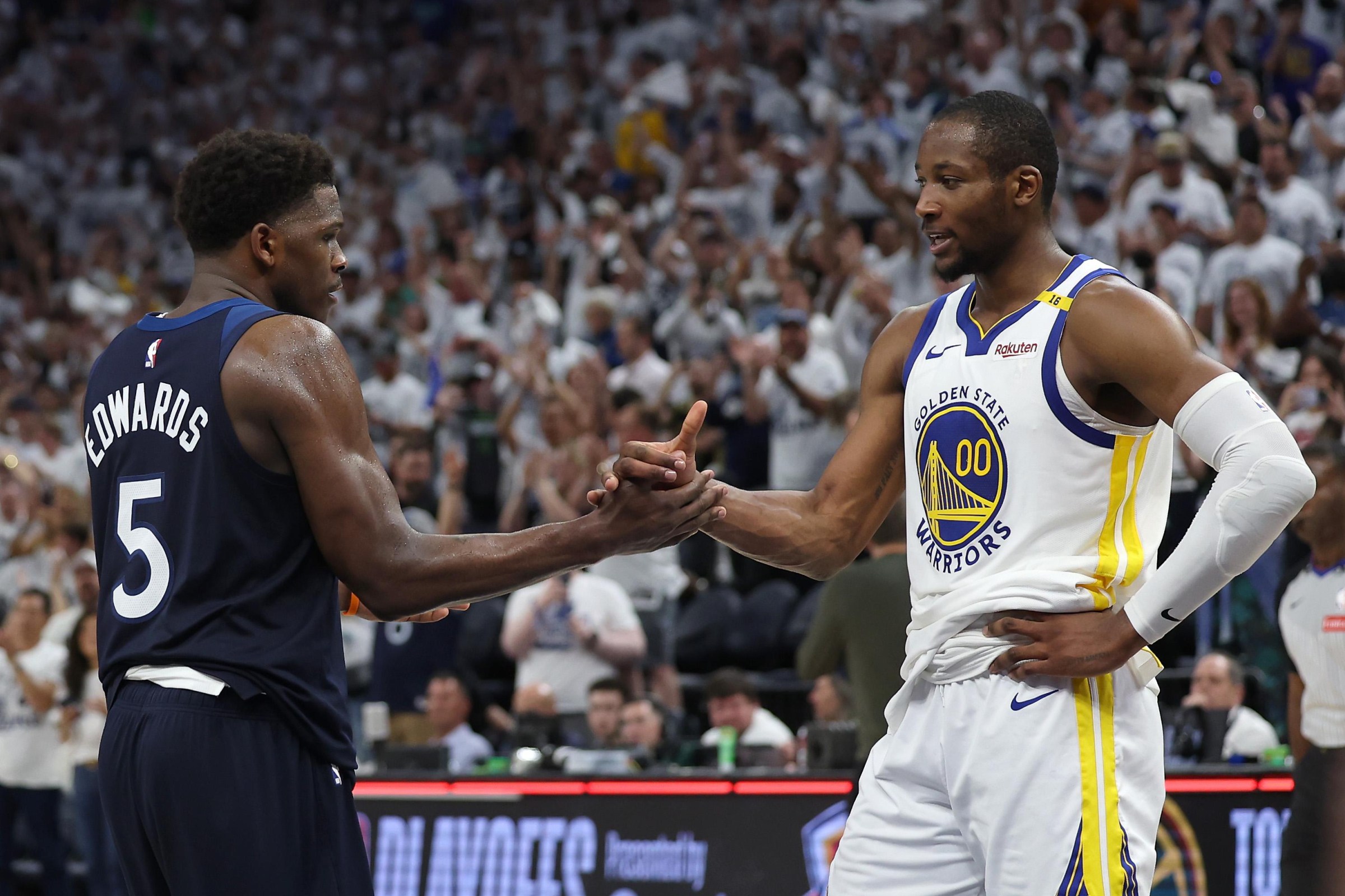 MINNEAPOLIS, MINNESOTA - MAY 14: Anthony Edwards #5 of the Minnesota Timberwolves shakes hands with Jonathan Kuminga #00 of the Golden State Warriors after winning Game Five of the Western Conference Second Round NBA Playoffs at Target Center on May 14, 2025 in Minneapolis, Minnesota. NOTE TO USER: User expressly acknowledges and agrees that, by downloading and or using this photograph, User is consenting to the terms and conditions of the Getty Images License Agreement. (Photo by Ellen Schmidt/Getty Images)