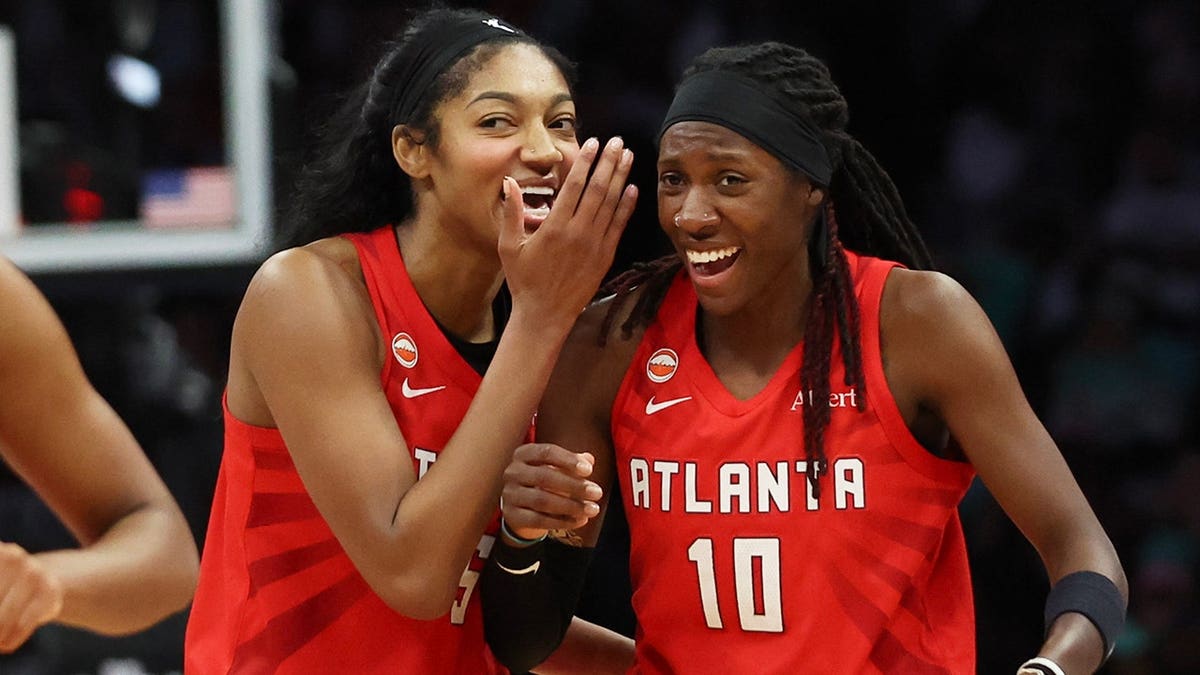Angel Reese and Rhyne Howard of the Atlanta Dream react after defeating the New York Liberty.