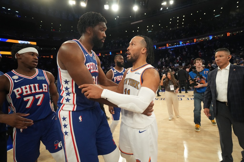 Joel Embiid of the Philadelphia 76ers and Jalen Brunson of the New York Knicks talk on the court after a game.