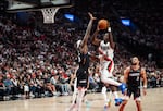 Portland Trail Blazers guard Jrue Holiday drives the ball as Phoenix Suns center Duop Reath defends.
