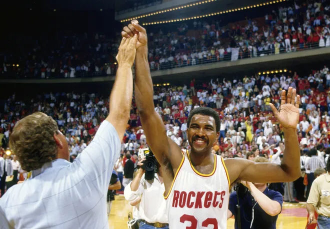 Unknown date; Houston, TX, USA; FILE PHOTO; Houston Rockets forward Robert Reid (33) high fives a fan against the Boston Celtics in the 1986 NBA Finals at the Summit. Mandatory Credit: MPS-USA TODAY Sports