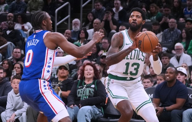 Boston Celtics forward Paul George (13) drives to the basket against Philadelphia 76ers guard Tyrese Maxey (0) during the first half of a preseason NBA basketball game, Saturday, Oct. 10, 2026, in Boston. (AP Photo/Charles Krupa)
