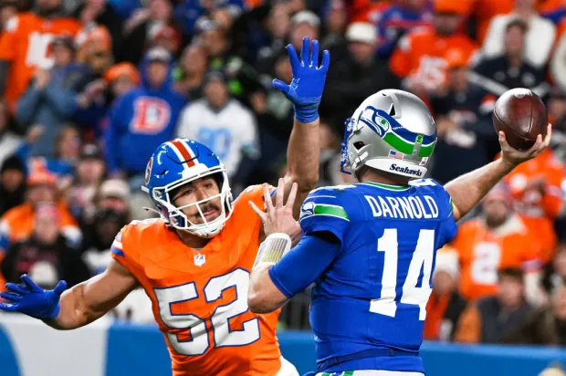 Denver Broncos outside linebacker Jonah Elliss (52) pressures Seattle Seahawks quarterback Sam Darnold during the first half of an NFL football game in Denver, Thursday, Oct. 15, 2026. (AP Photo/Geneva Heffernan)