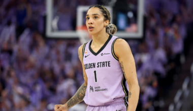 A female basketball player in a lavender Golden State jersey numbered 1 stands on the court with a focused expression and clenched fist.