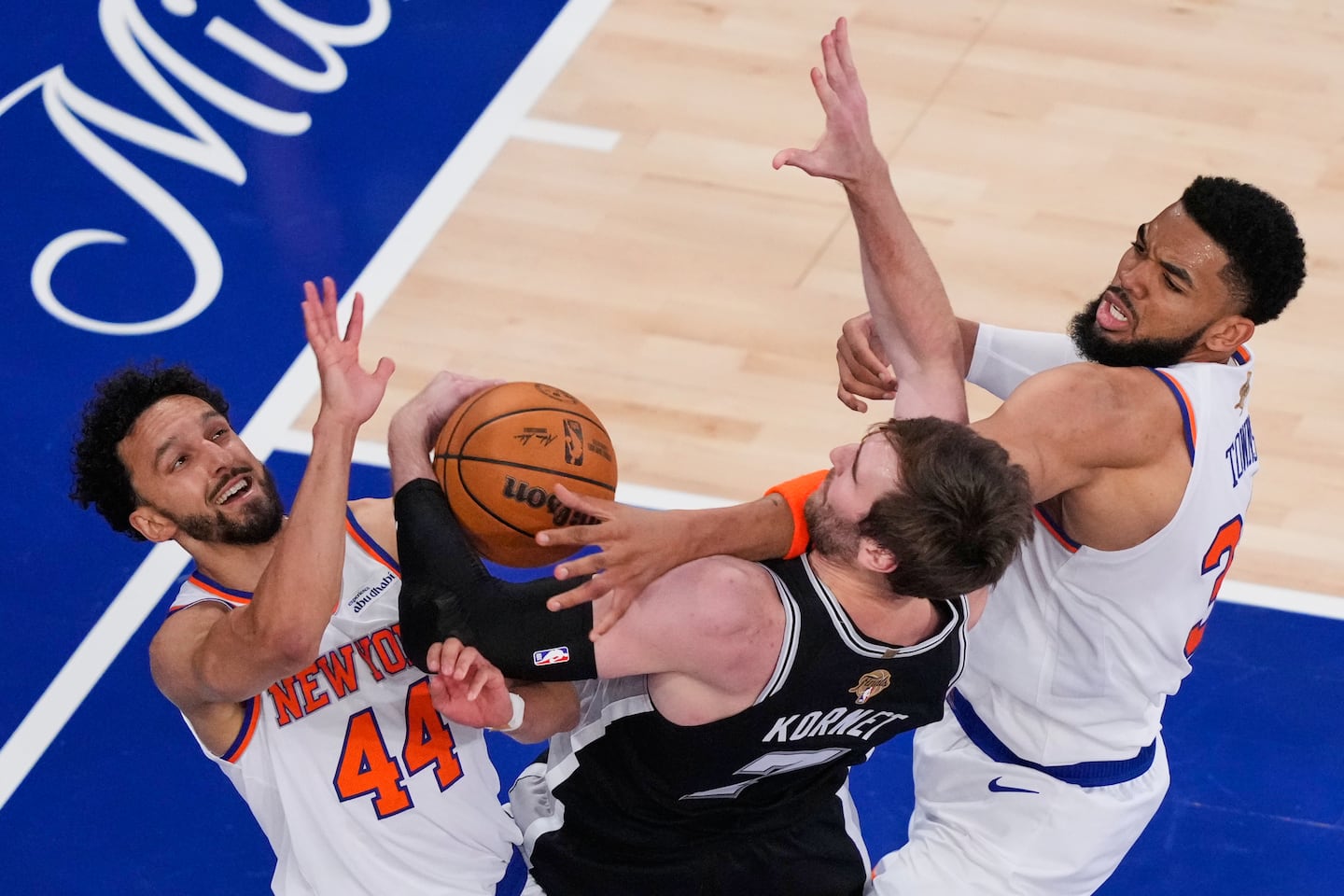 New York Knicks guard Landry Shamet (44) and center Karl-Anthony Towns (32) battled for the ball against San Antonio Spurs center Luke Kornet (7) during the second half of Game 3 of the NBA Finals in June. The Knicks won the series in five games, but lost Game 3 - when President Trump was in attendance.