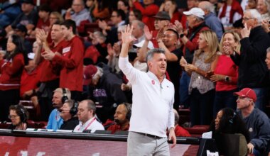 Kyle guy on the court with his hand in the air.