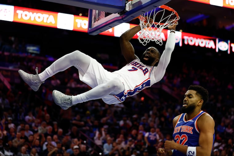 Sixers guard Jaylen Brown hangs on the rim after dunking the basketball in the second quarter.