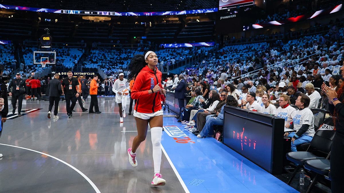 Angel Reese runs off the court at State Farm Arena.