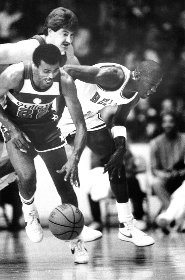 Michael Jordan (23), right, plays his first regular season game as a Chicago Bull on Oct. 26, 1984, against the Washington Bullets at the Chicago Stadium. (Charles Cherney/Chicago Tribune) 
