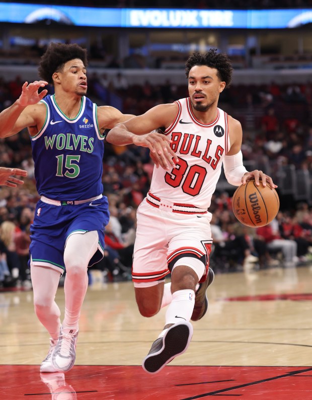 Bulls guard Tre Jones (30) advances the ball as Timberwolves guard Zyon Pullin (15) defends in the first quarter of a preseason game at the United Center on Oct. 16, 2026, in Chicago. (John J. Kim/Chicago Tribune)
