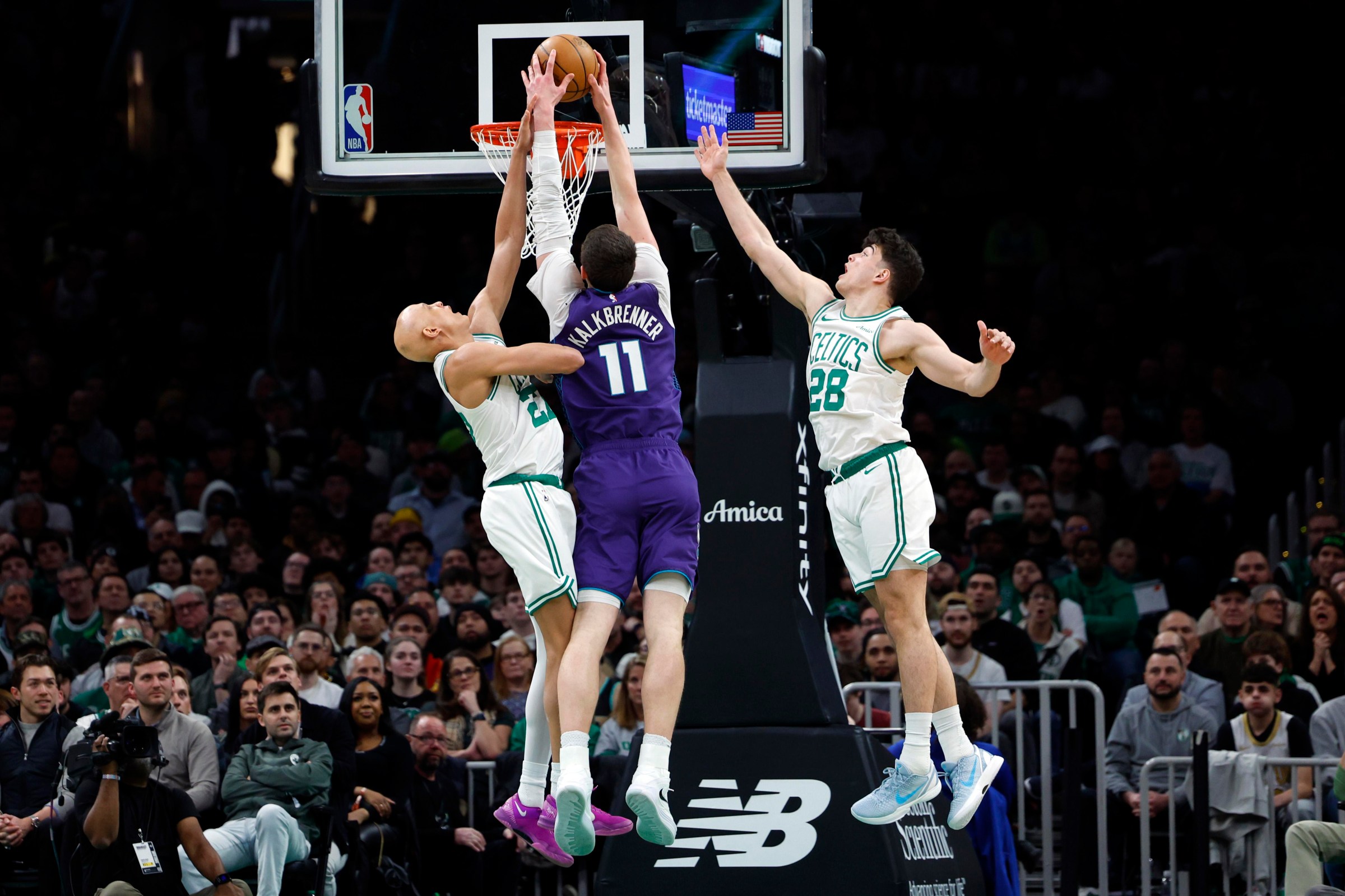 Boston, MA - March 4: Charlotte Hornets center Ryan Kalkbrenner dunks between Boston Celtics guards Jordan Walsh and Hugo Gonzalez in the third quarter. The Celtics played the Hornets at TD Garden on March 4, 2026. (Photo by Danielle Parhizkaran/The Boston Globe via Getty Images)
