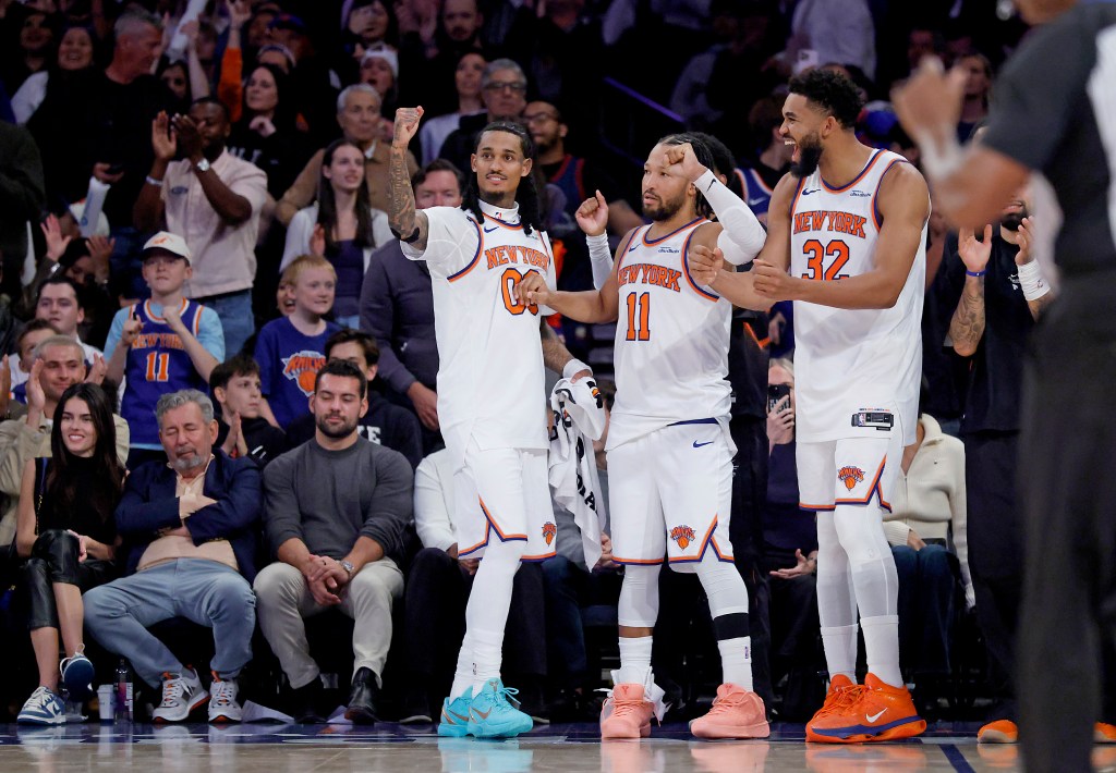 Knicks guard Jordan Clarkson (00), guard Jalen Brunson (11) and center Karl-Anthony Towns (32) react off the bench late during the fourth quarter against the Toronto Raptors at Madison Square Garden in New York, Thursday, Oct. 15, 2026. The New York Knicks defeated the Toronto Raptors 122-120.