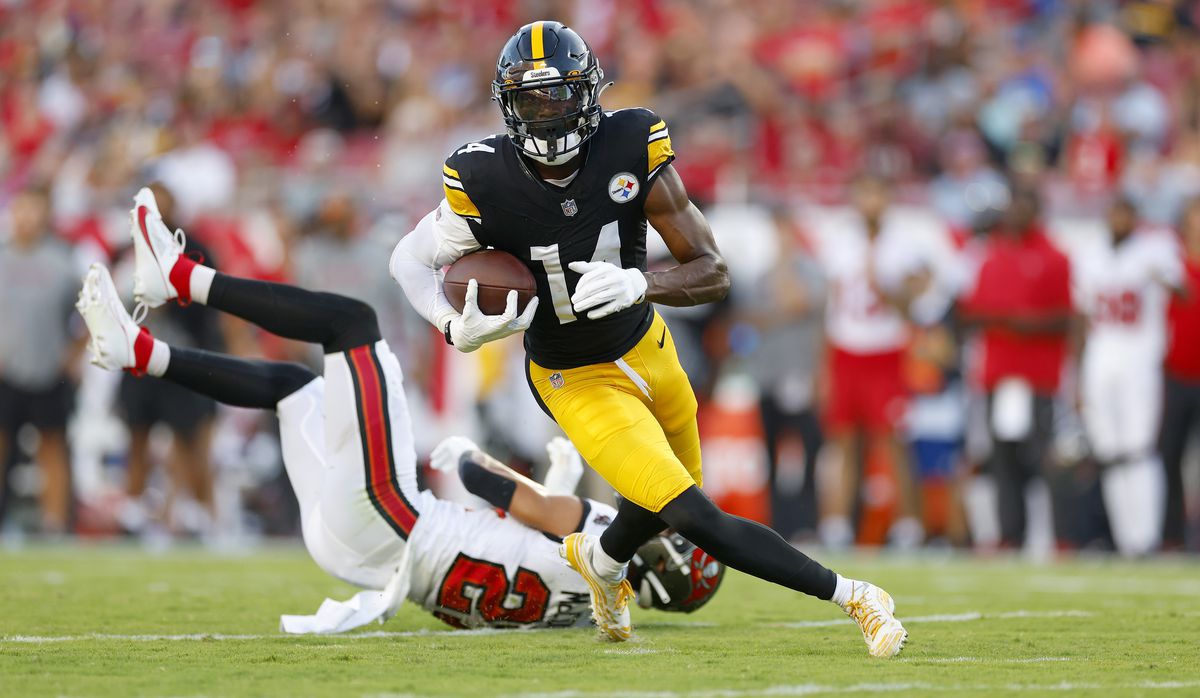 George Pickens #14 of the Pittsburgh Steelers rushes after a catch for a touchdown during a preseason game against the Tampa Bay Buccaneers at Raymond James Stadium on August 11, 2023 in Tampa, Florida.