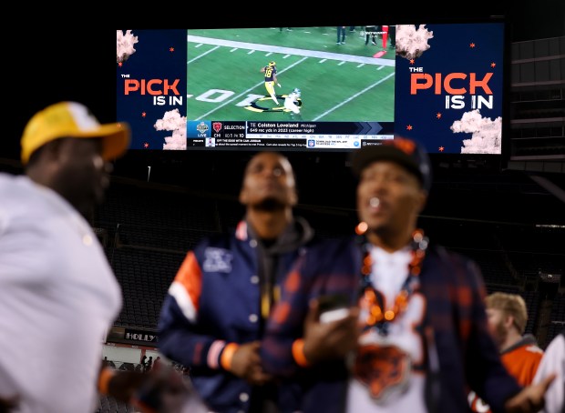 Fans attending a Bears draft party at Soldier Field watch highlights of Colston Loveland after the Michigan tight end was selected at No. 10 on April 24, 2025. (Chris Sweda/Chicago Tribune)