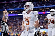 Texas Longhorns quarterback Quinn Ewers (3) celebrates his fourth quarter touchdown run...